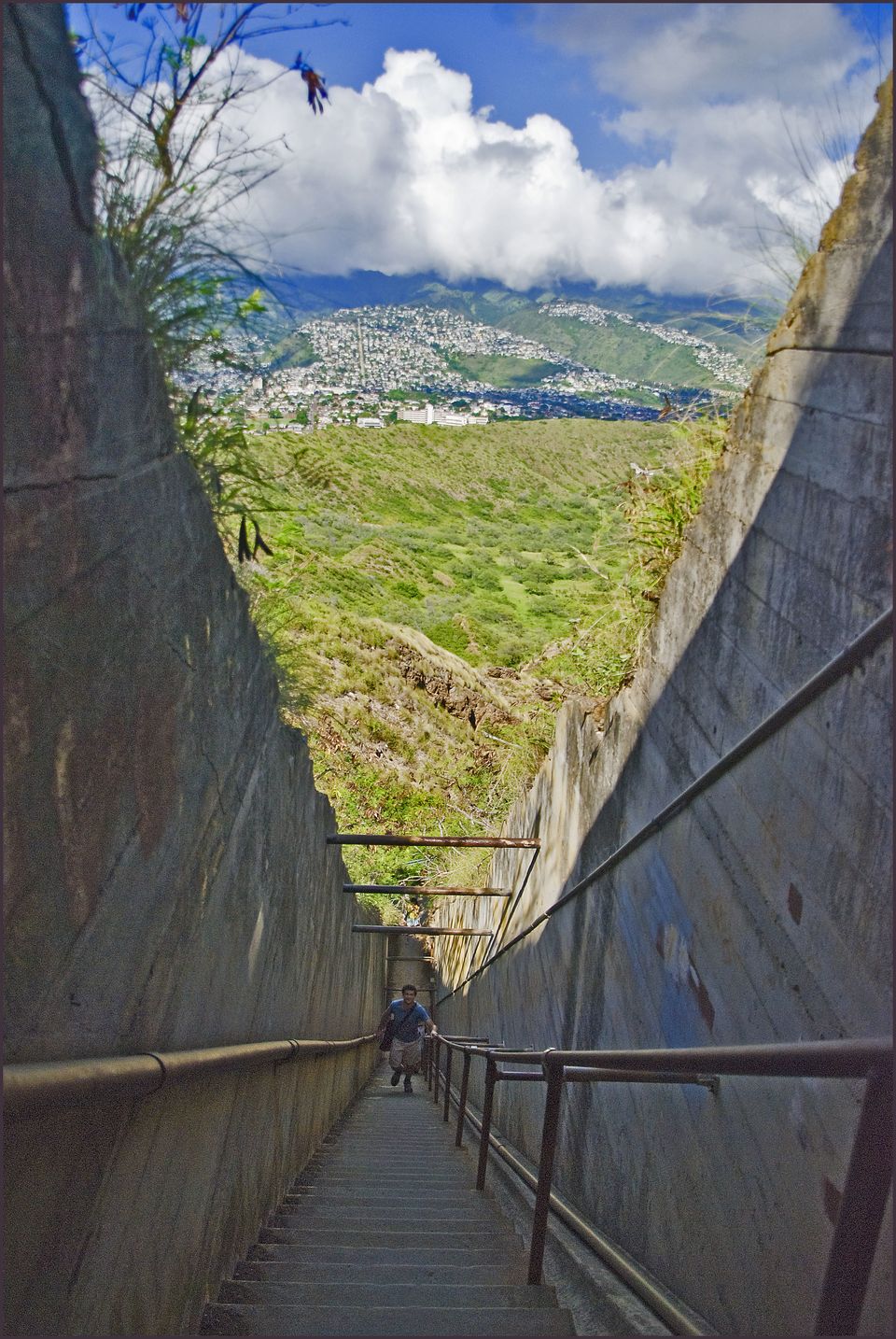 A long concrete stair climbing between rock walls