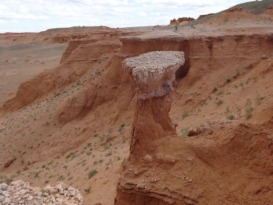 Wind-carved sandstone pillars on a desert slope