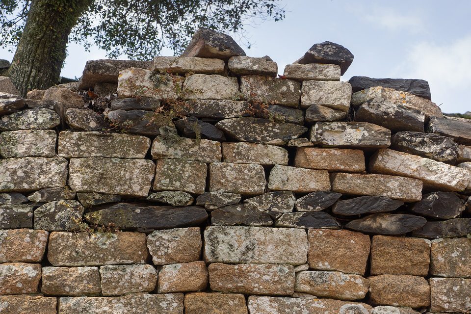 Granite blocks laid without mortar at the top of a Great Enclosure wall, crusted with lichen