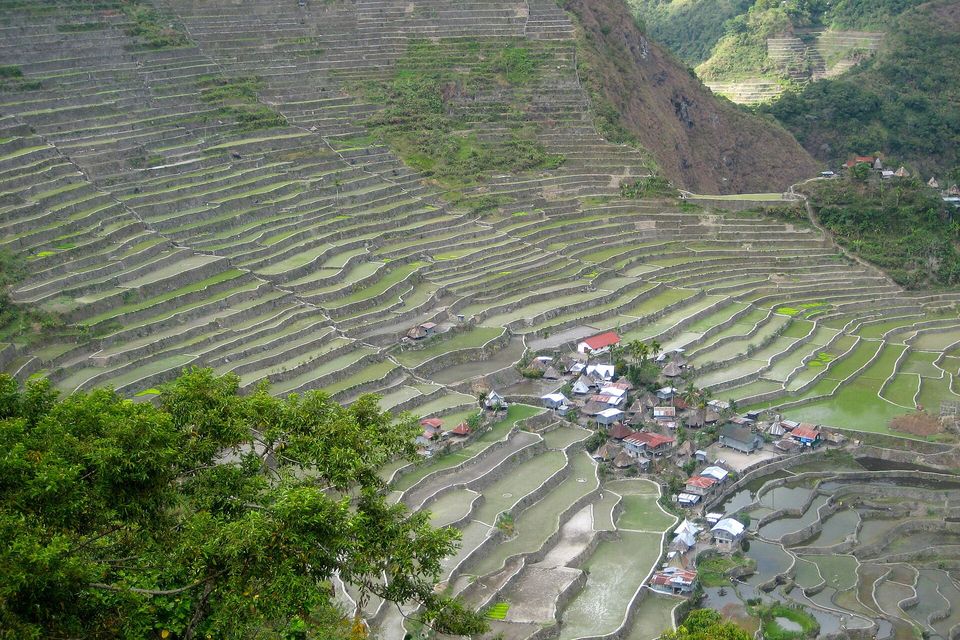 Batad village sits in a bowl of flooded rice terraces, the water catching the sky