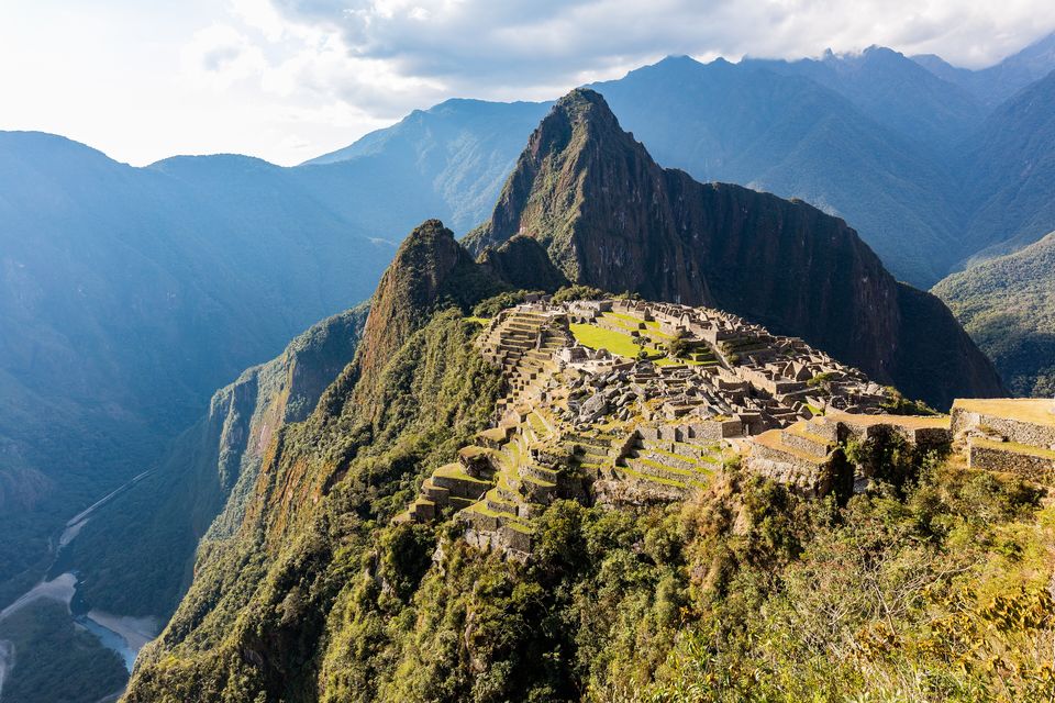 The citadel on its ridge seen from above, steep green mountains all round and a river curving far below