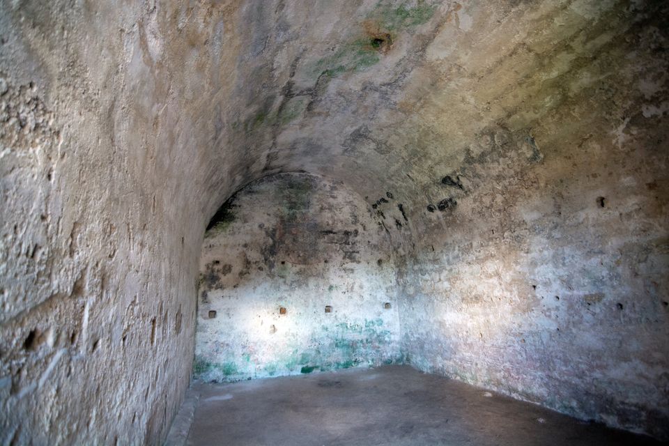 The curved, pale stone ceiling of a vaulted room inside a fort