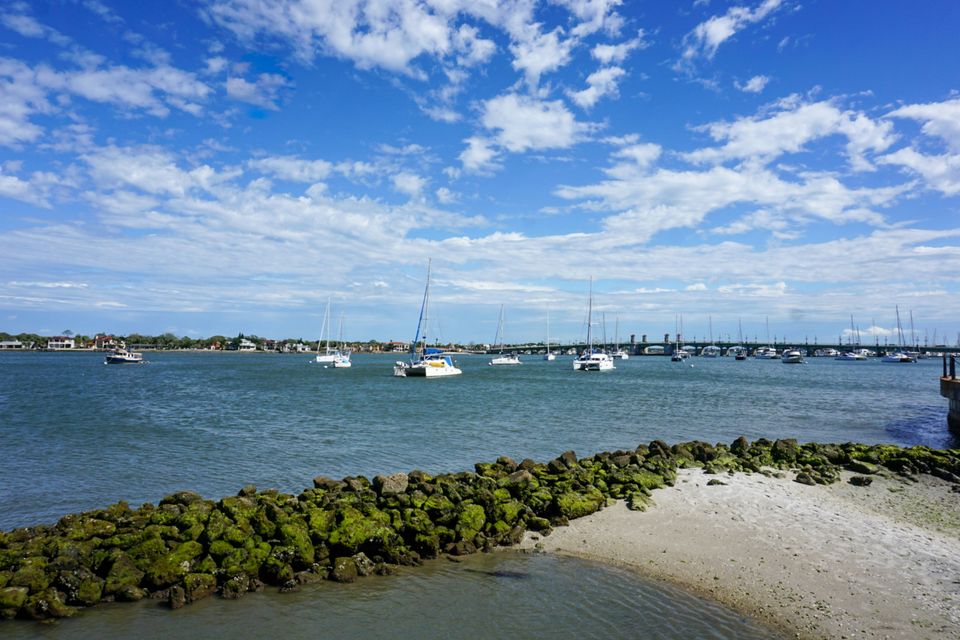 Boats in Matanzas Bay with the city marina and a bridge in the distance