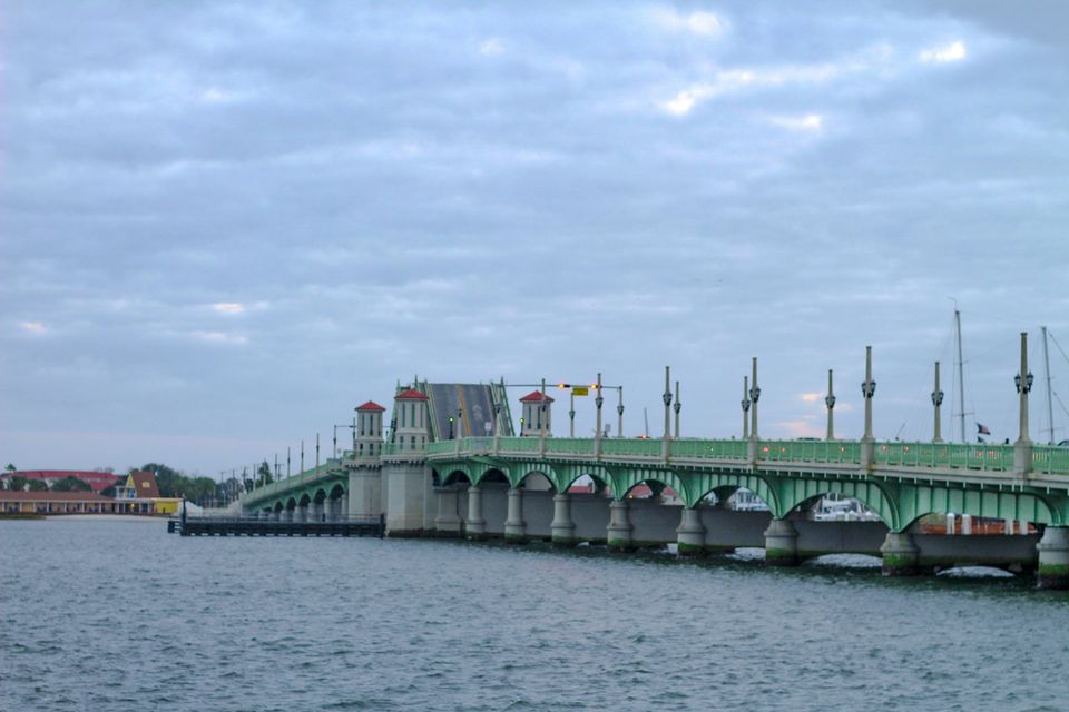 A white bridge with towers crossing a bay