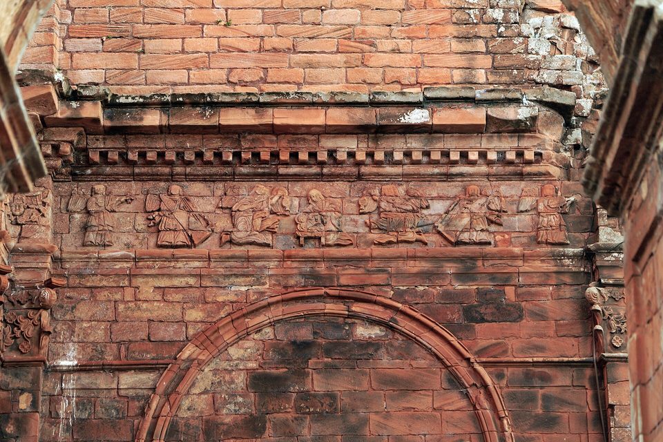 A frieze of carved angels cut into sandstone
